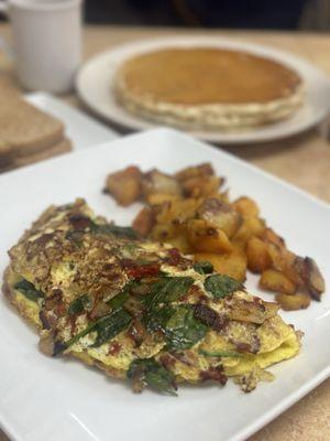 Spinach omelette (foreground) short stack pancakes (background)