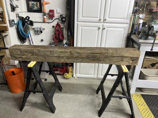 Reclaimed wood beam for fireplace mantle.