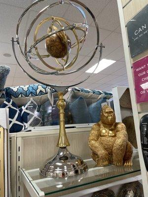 White rotating metal ornaments with a wooden dial and gorilla.