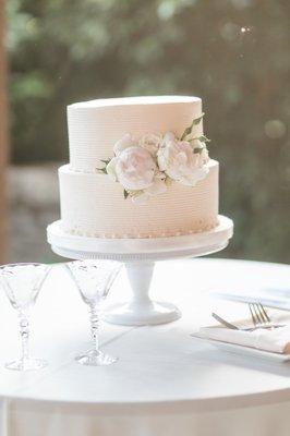 This is the cake on the cake stand with a Styrofoam bottom. It looks like a 3 tiered cake missing a top.