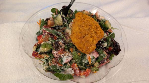 Large mixed salad with spicy breaded chicken, delicious! About $15.