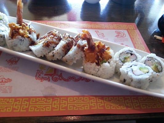 A shrimp tempura roll flanked by a California roll