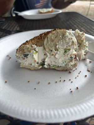 Delicious onion bagel with extra vegetable cream cheese