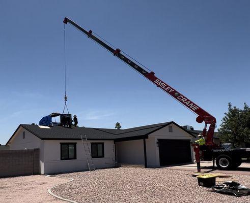 Crane operation for replacing old AC unit.