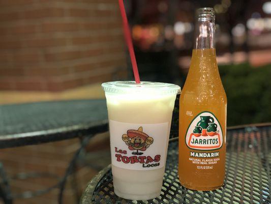 Cup of horchata and bottle of orange Jarritos soda.