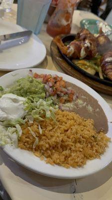 Rice and beans that come with Sizzling Mesquite Shrimp Brochettes