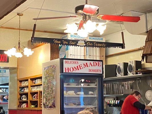 Note the sign on the saw above the cooler full of desserts.