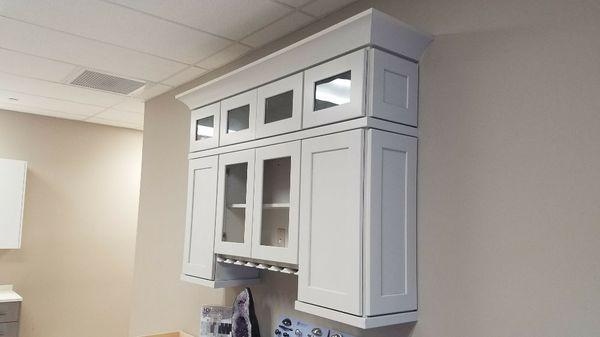 Stacker cabinets with glass doors and crown moulding.