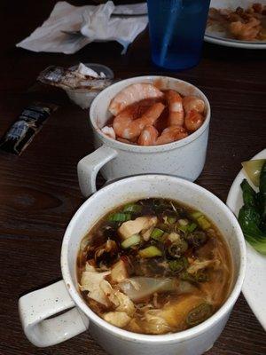 Hot and Sour soup in front and boiled shrimp with cocktail sauce in a mug in back!