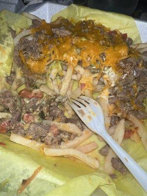 carne asada fries , with watery pico de gallo