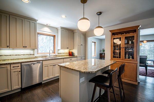 Previously stained and finished maple cabinets become professionally painted