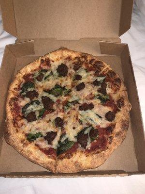 Vegan pizza with Impossible Sausage and Spinach