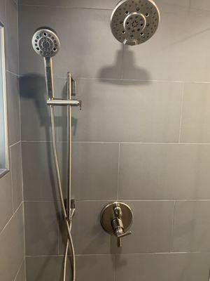 Brushed nickel rain and detachable shower fixtures.