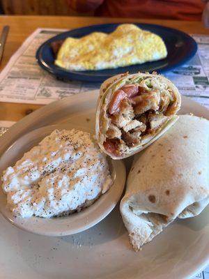 Buffalo Ranch Chicken Wrap with a side of cottage cheese, and a Meat Lovers Omelet in the background