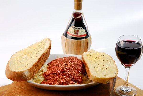 Spaghetti with meat sauce complemented with garlic toast.