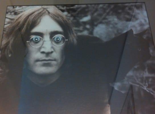 Googly eyed John Lennon (and his black cat) watches over all who enter, from the hallway corner.