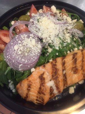 Grilled salmon over garden salad