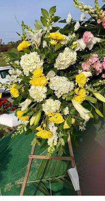 Deluxe White Tribute Spray customized with yellow flowers. Amazing and beautiful arrangement.