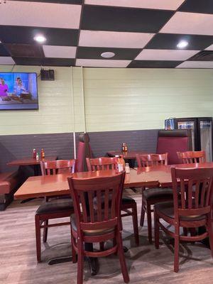 Part of the dining room with same old furniture and a third flat screen