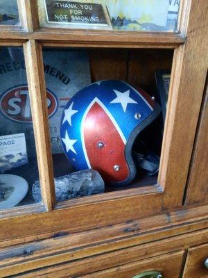 In the lobby, the owner displays his vintage Knievel helmet in an heirloom cupboard from way back in his family.