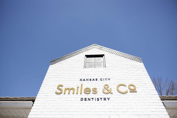 The exterior of Kansas City Smiles & Co., a modern dental practice in Independence, MO.