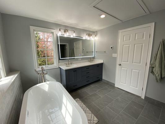 douuble vanity with quartz countertop and light up mirror.