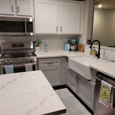 After: new quartz tops, extended island, refaced/repainted fronts, new sink, new backsplash