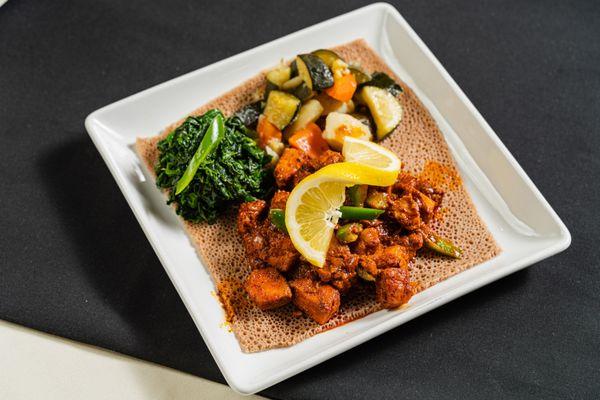 Sautéed chopped Tuna with Ethiopian spices, olive oil, cardamom, and sliced jalapenos. Served with two veggie sides and injera.