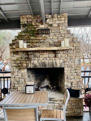 Nice covered outdoor seating and with a fireplace.