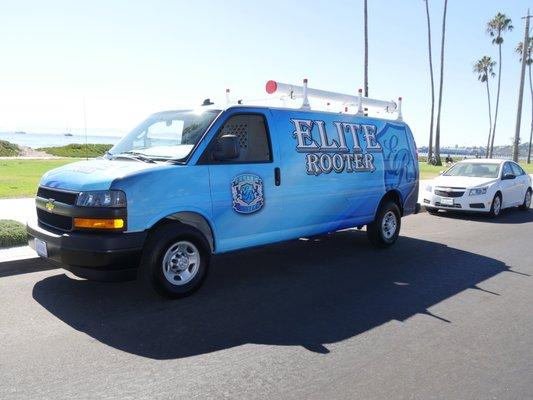 Elite Rooter van parked along a scenic street, ready to provide expert plumbing services to the community.