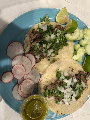 2 asada tacos $2.50 each; comes with cilantro, onion, radish, cucumber, and salsa Verde. corn tortilla