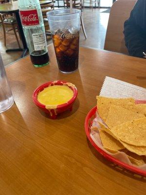 Chips, queso and coke.