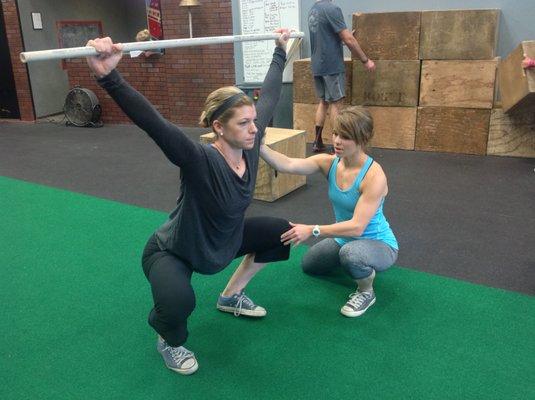 Dr. C helping an athlete with her movement patterns