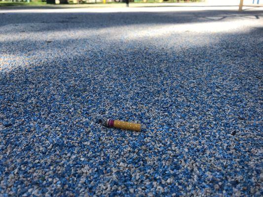 Cigarette butts at children's playground at 9:27am