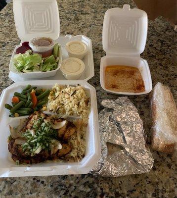 Chicken lunch plate comes with pilaf, veggies, bread and a side of soup or salad! Hummus and garlic sauce are THE BEST.