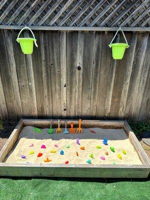 Sand box to promote sensory exploration, motor skills and full happiness while at the daycare.