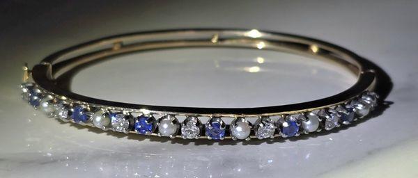 14K Yellow Gold Natural Sapphire, Diamond and Saltwater Cultured Pearl Bangle Bracelet.

LisaJewelers.com