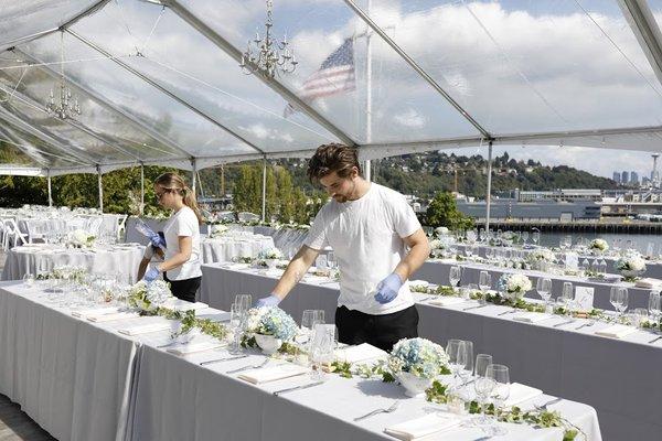 Staff helping with table set up