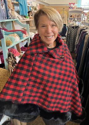 Experience the cozy warmth of our pullover poncho, showcasing a distinctive neckline in a striking red and black plaid pattern. Perfect for.