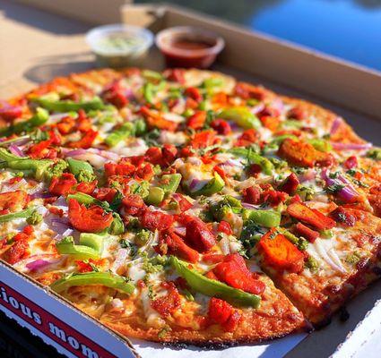 COVID TAKEOUT: CTM Pizza w/ tandoori chicken, tikka masala sauce, onions, bell peppers, mint+tamarind chutneys | M - $16.99 (extra spicy)