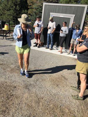 Jamie, involved supporters and consultants and gardeners at the Commons Park ribbon cutting. The garden shed is behind several gardeners.