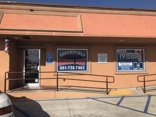 Front of Bakersfield cell phone repair and Bakersfield Barber Shop.