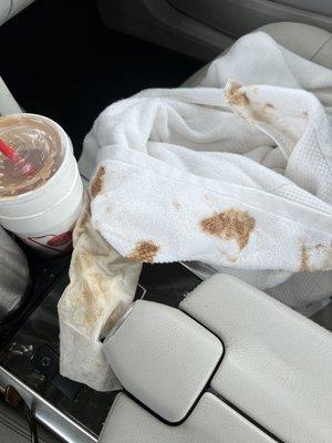 This is after clean up. My cup holder is perfect. No snags. Luckily I had a dog towel in back seat. My top will need dry cleaning shorts