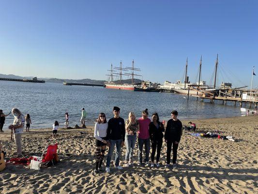 Nice small beach with ships in the background