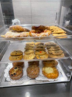 Cherry and cheese Danish, blueberry and apple strudel muffins, chocolate chip, M&M chocolate chip, and macadamia cookies