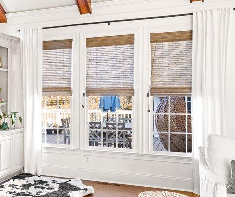 Layering roman shades with drapery in this Nashville, TN customer's primary bedroom adds depth and style, enhancing the room's overall look.