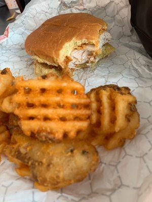 Hot and spicy chicken sandwich with waffle fries.