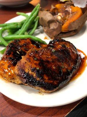 Honey glazed chicken breast with baked sweet potato and green beans.