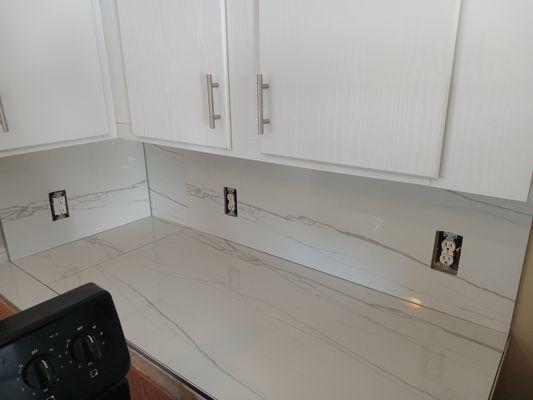 Tiling counter top and backsplash.