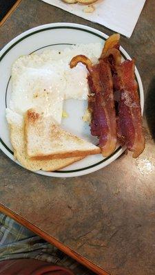 Awesome, perfectly cooked eggs, thick cut bacon,  and real buttered toast!